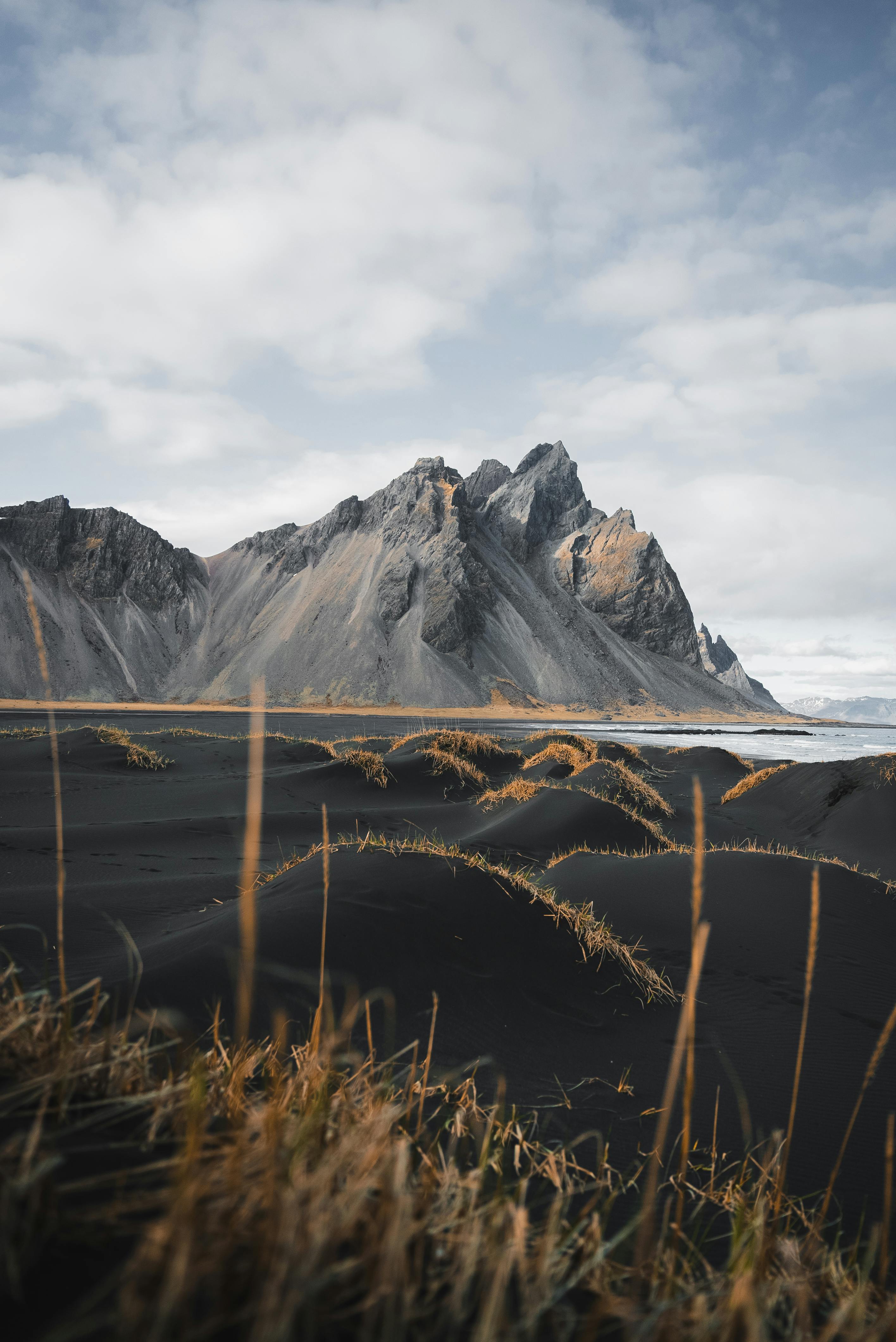 Majestic Vestrahorn mountain with black sand dunes, capturing Iceland's raw beauty.