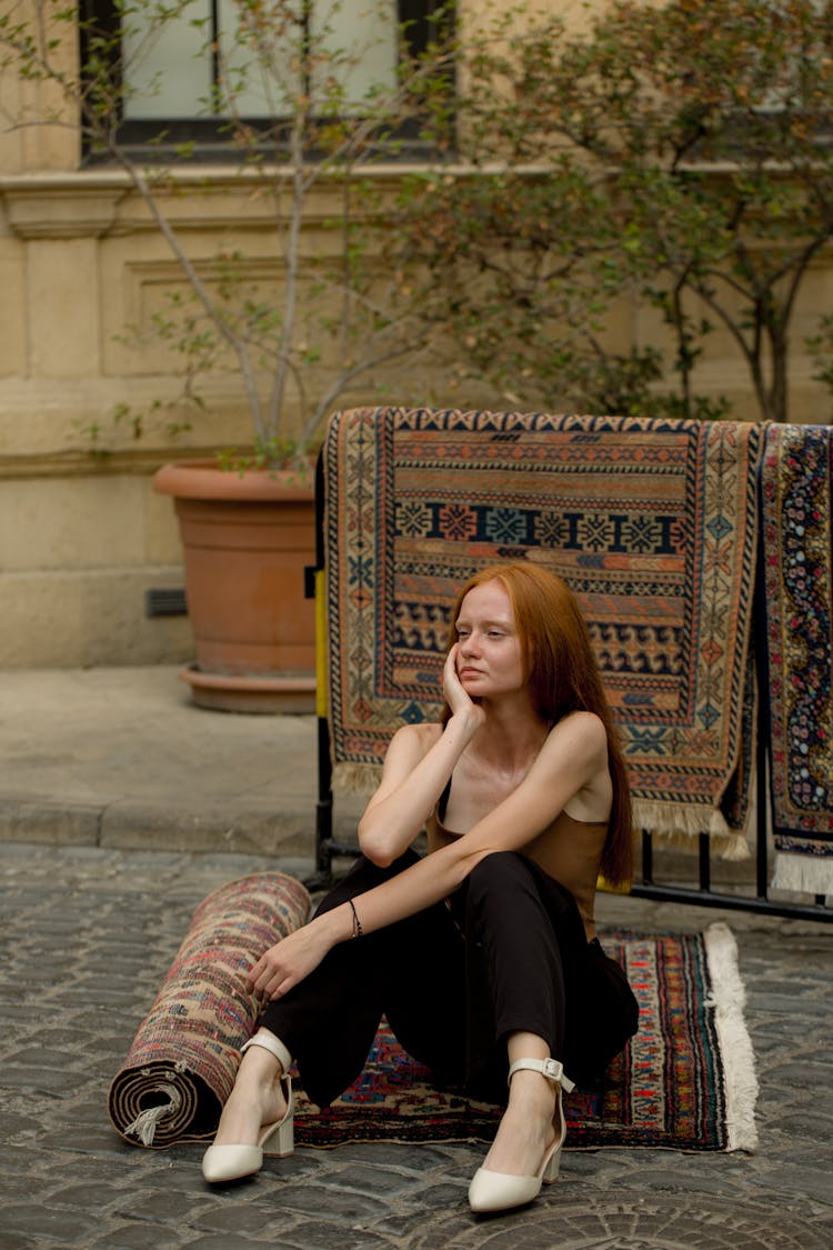 Woman Sitting On Turkish Carpet At Street