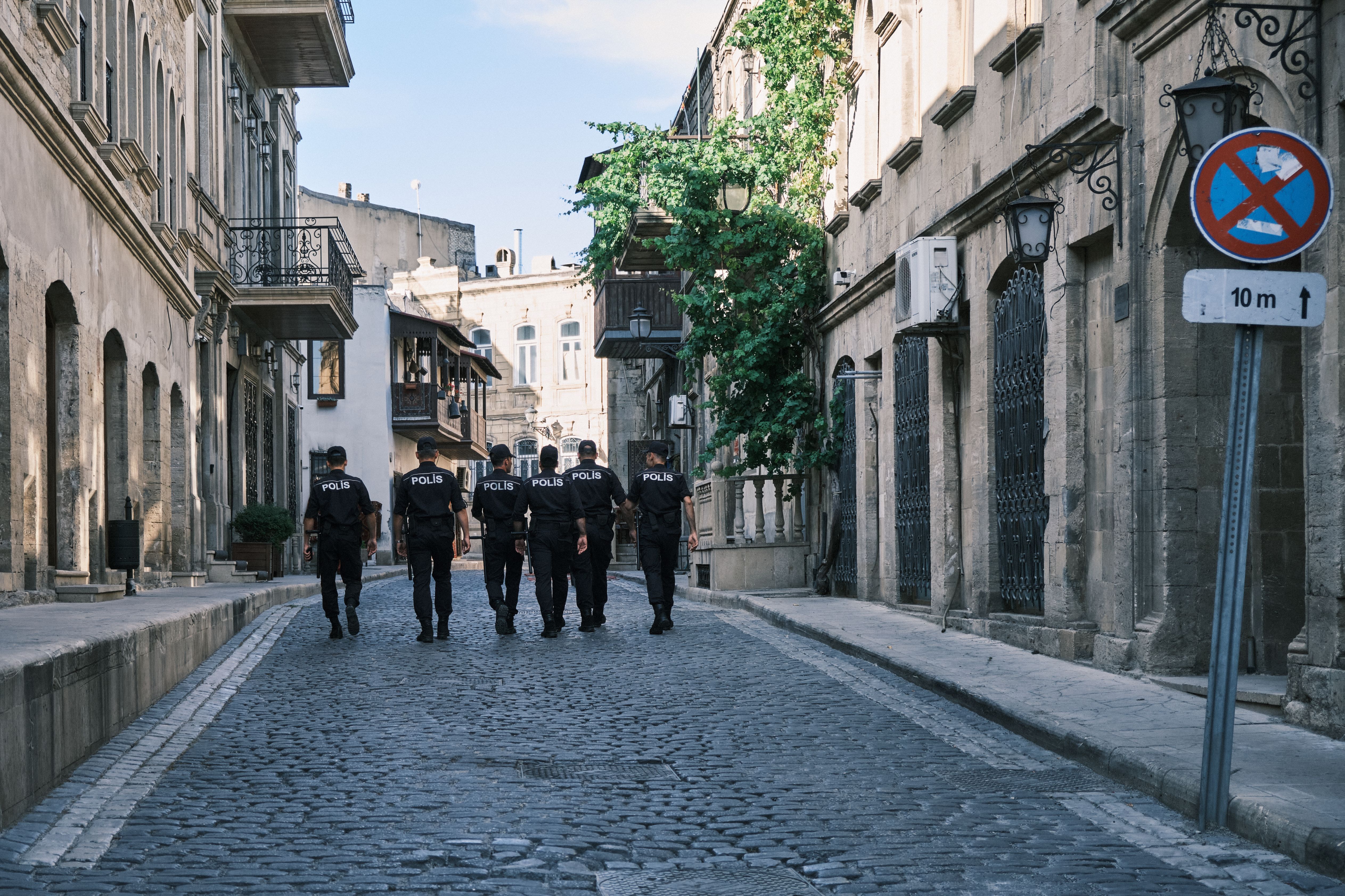 Policemen Walking on Paving Street · Free Stock Photo