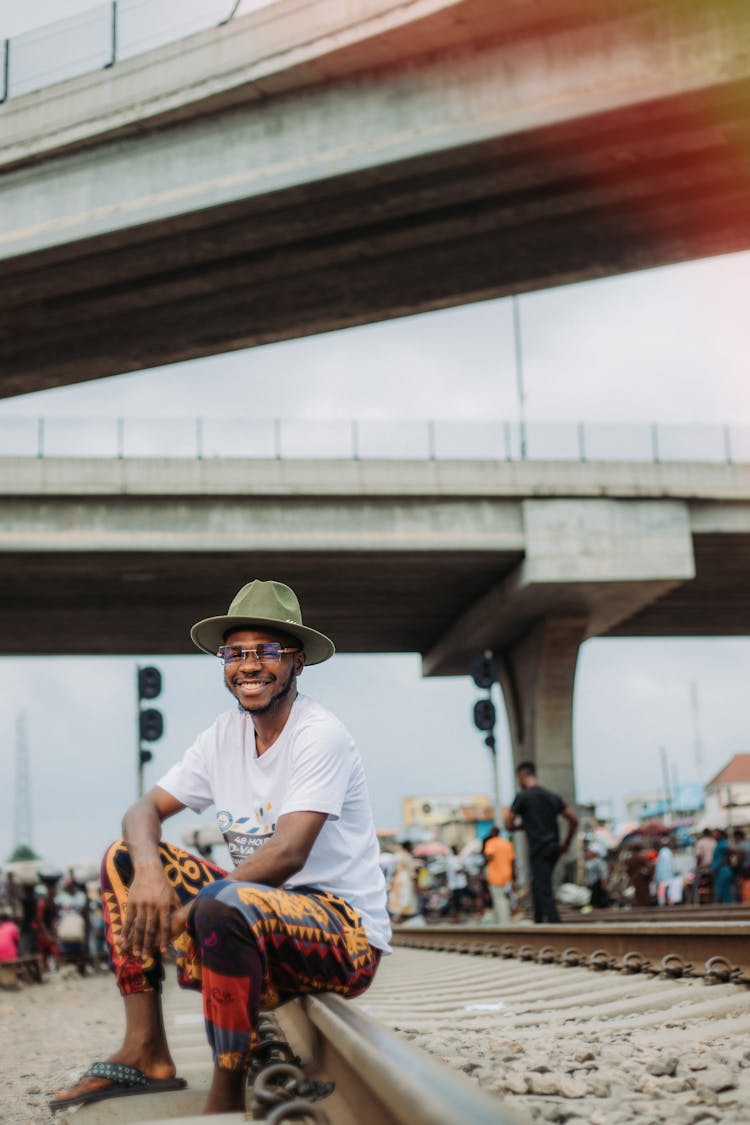 A Happy Man Sitting On The Railway 