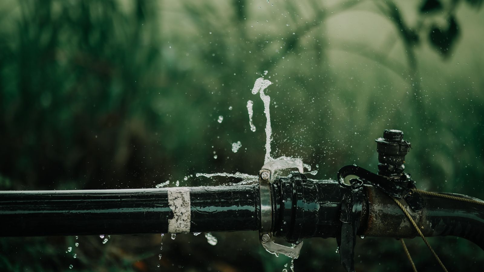 Water spraying from a leaking pipe joint