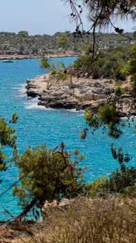 Turquoise waters and rocky coastline of Silifke captured in vibrant daylight.