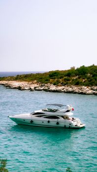 A luxury yacht anchored in the turquoise waters off the coast of Silifke, Mersin, Türkiye, showcasing a serene oceanic view.