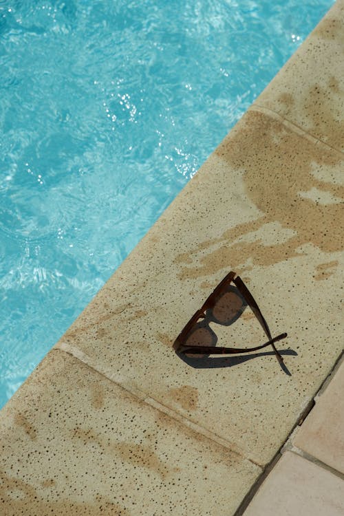 Sunglasses on Ground near Swimming Pool