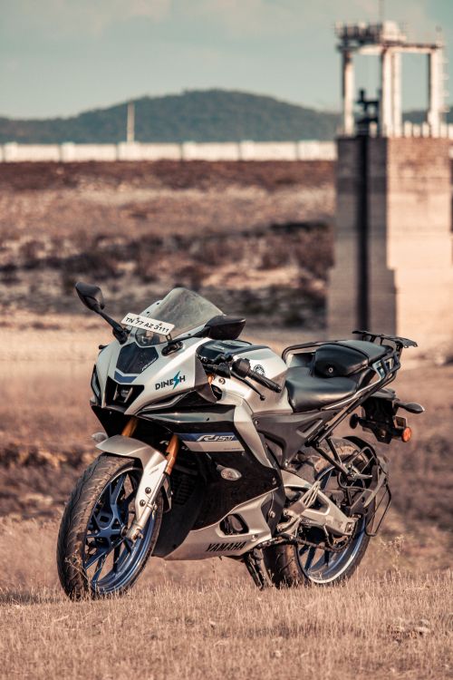Free A sleek Yamaha motorcycle parked in a rustic field, perfect for travel and adventure enthusiasts. Stock Photo