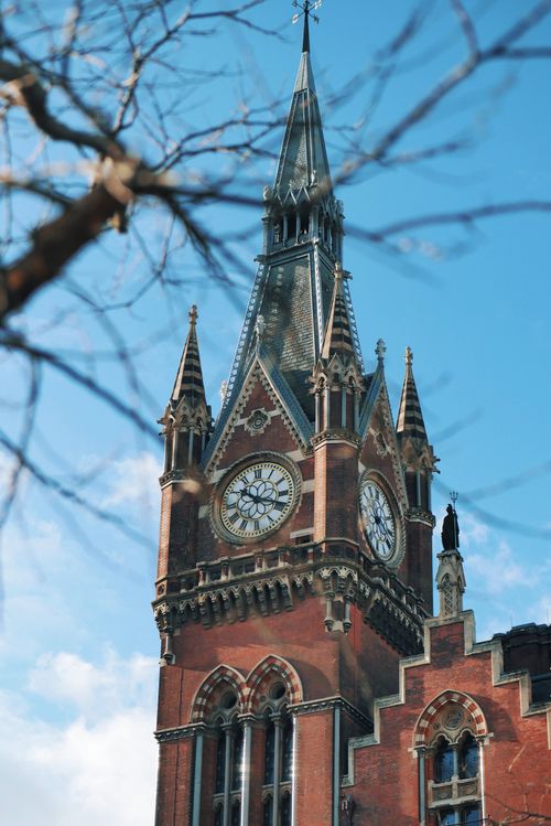 Free Close-up of the iconic Gothic clock tower at St. Pancras Station, London, on a clear day. Stock Photo
