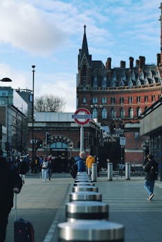 Buzzing scene at St. Pancras Station, London with urban architecture and commuters.
