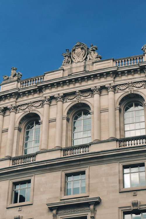 Free Detailed view of ornate architectural facade with clear blue sky background. Stock Photo