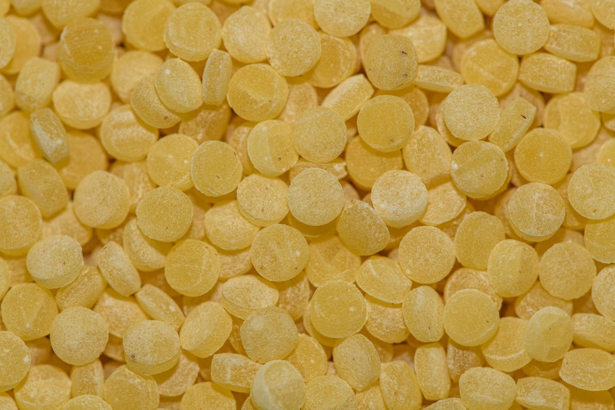 A high-resolution close-up of yellow candy discs, ideal for backgrounds or textures.