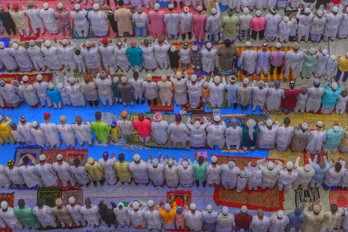 Free A vibrant overhead shot of people in traditional attire gathered in prayer, showcasing cultural diversity. Stock Photo