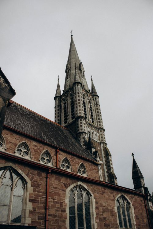 Free Vertical shot of a Gothic church spire, showcasing intricate architectural details. Stock Photo