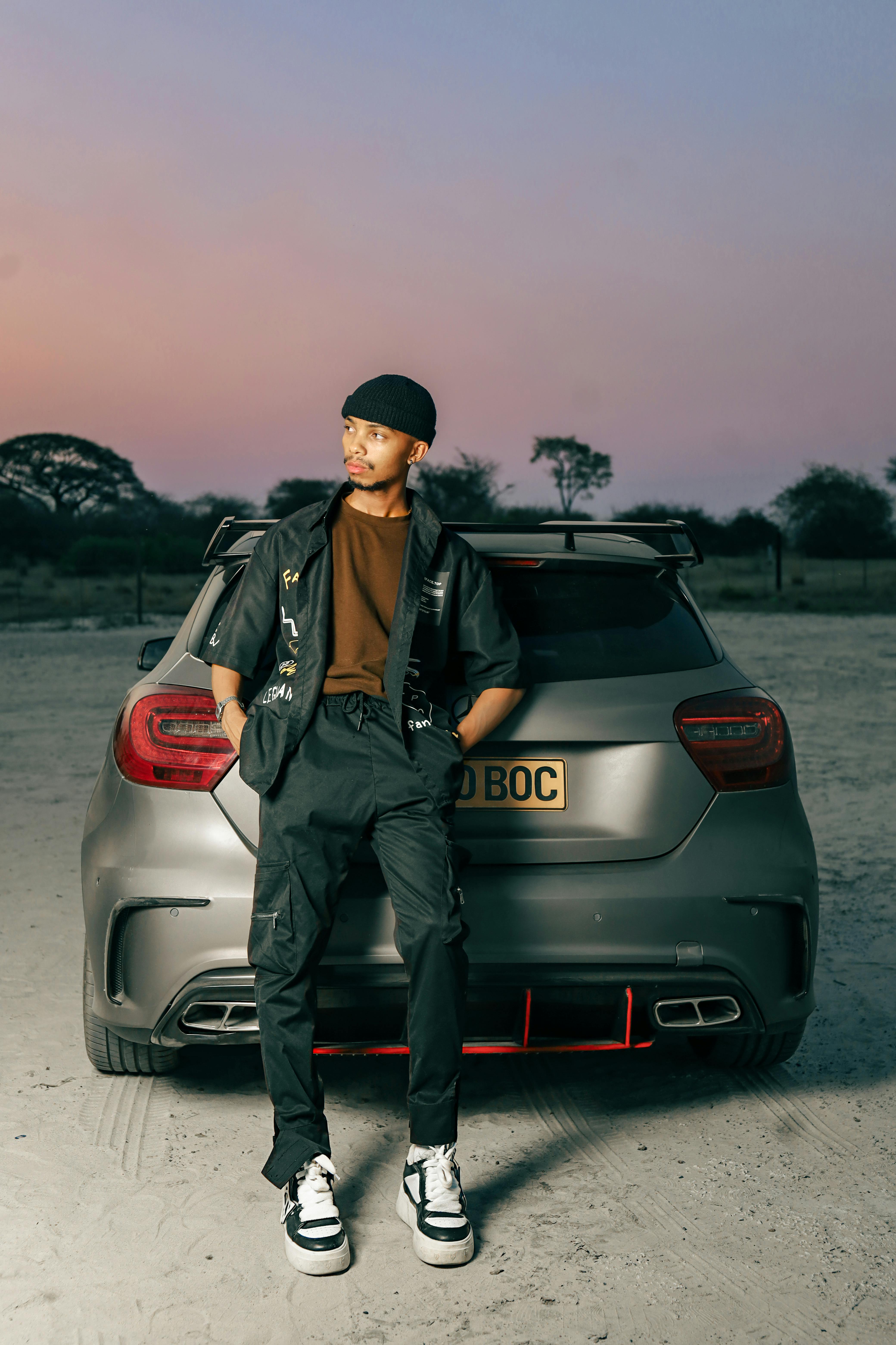cropped view of stylish man in denim posing near car Stock Photo by  LightFieldStudios