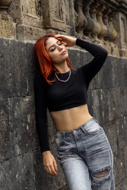 Portrait of a Female Model Leaning on a Wall