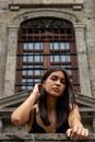Stunning portrait of a young woman with long hair against a historic building in Guadalajara.