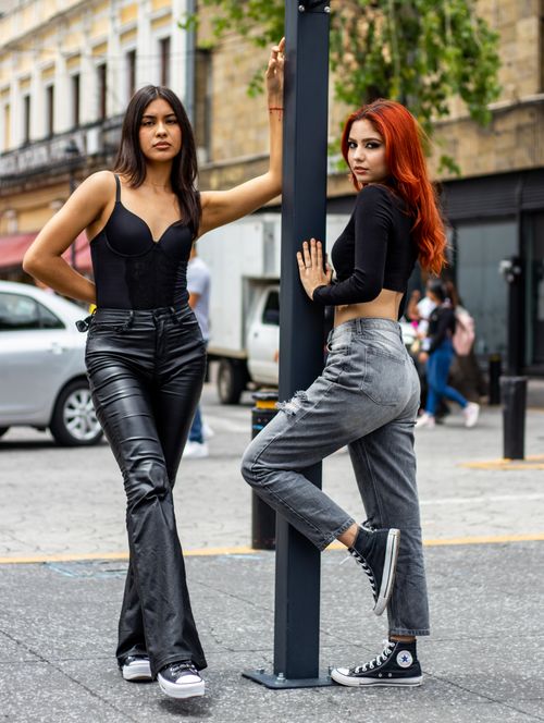 Free Two young women pose stylishly on a street in Guadalajara, México, showcasing urban fashion with confidence. Stock Photo