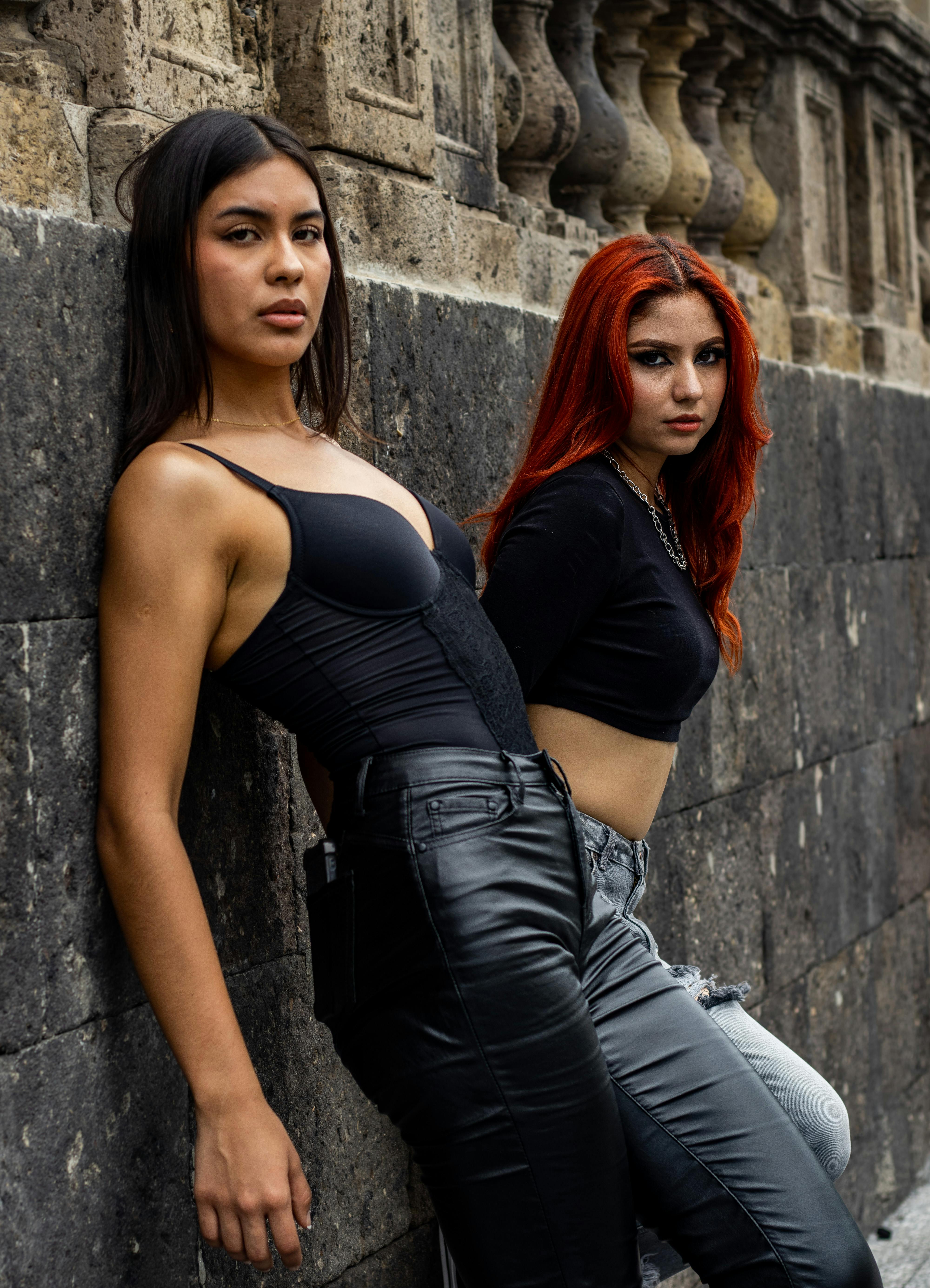 Two women in leather pants and black tops · Free Stock Photo