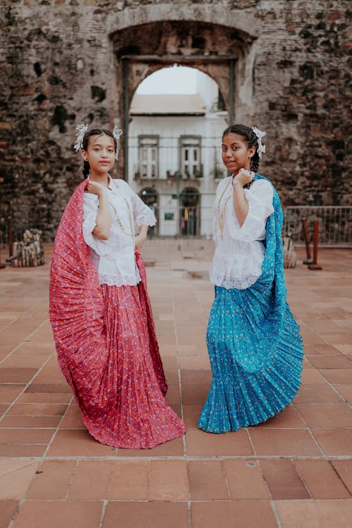Portrait of Two Girls Wearing Long Traditional Skirts