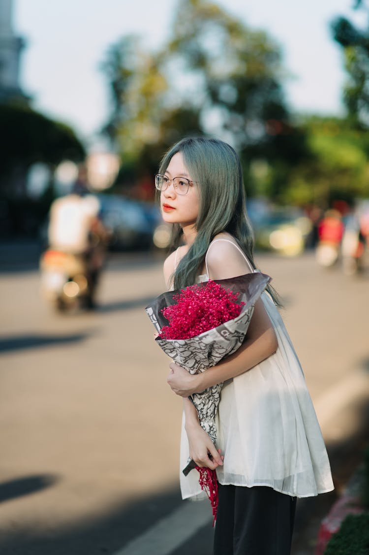 Teenager With A Bouquet Of Pink Flowers On The Sidewalk