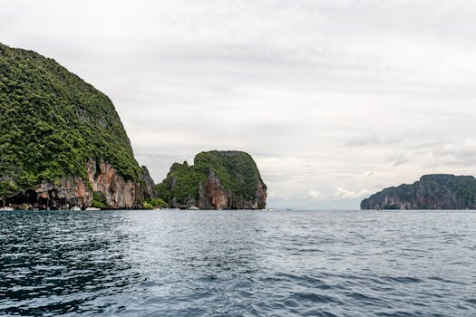 Explore the breathtaking limestone cliffs and serene sea in Phuket, Thailand.