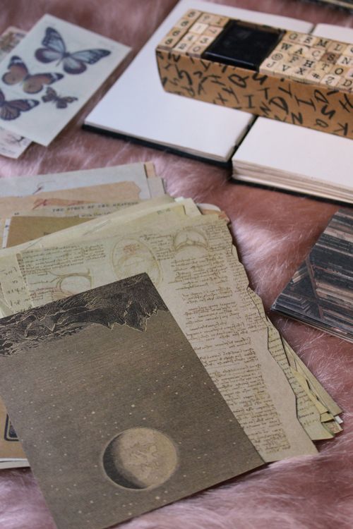 collection of vintage scrapbooking materials with papers and stamps