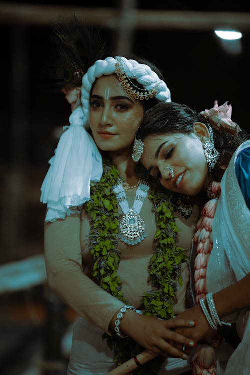 Young Women Wearing Traditional Clothes, Jewelry and Floral Garlands 