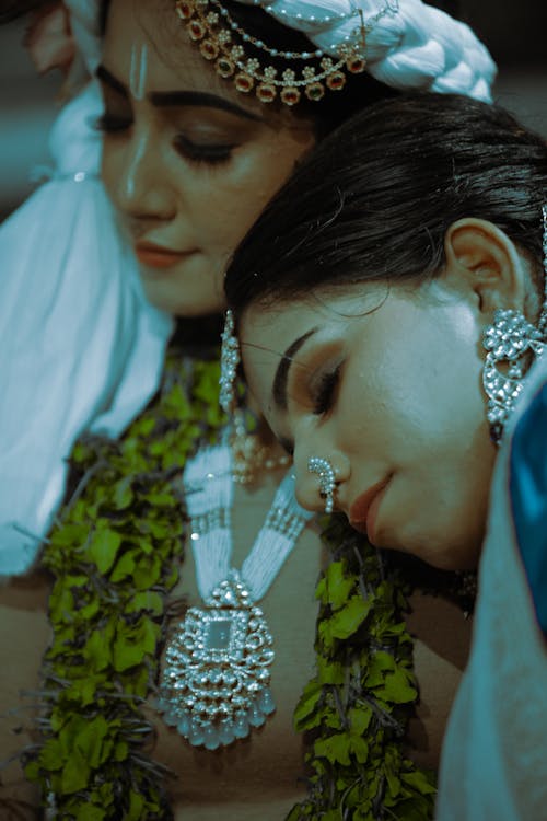 Young Women Wearing Traditional Clothes and Jewelry