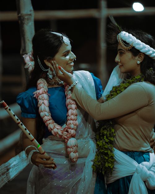 Free Two Indian women in traditional attire sharing a joyous moment during a cultural festival with garlands. Stock Photo