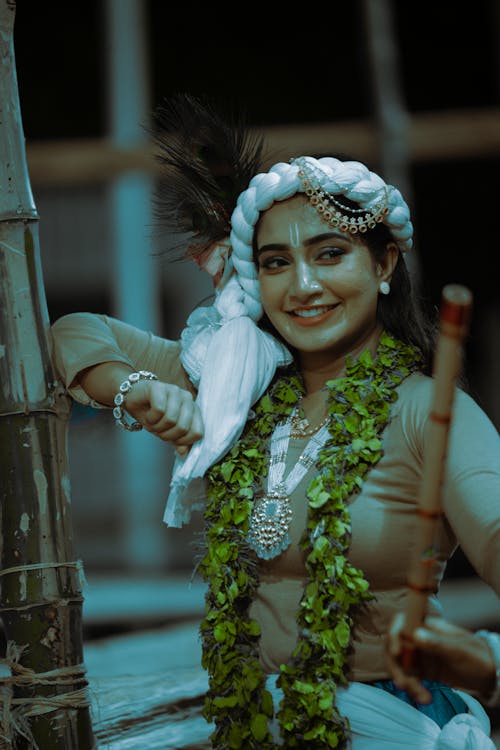 Young Woman Wearing Traditional Clothes, Jewelry and a Floral Garland