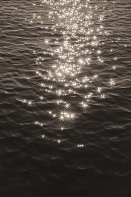 Captivating sunlight sparkles creating a stunning pattern on ocean waves.