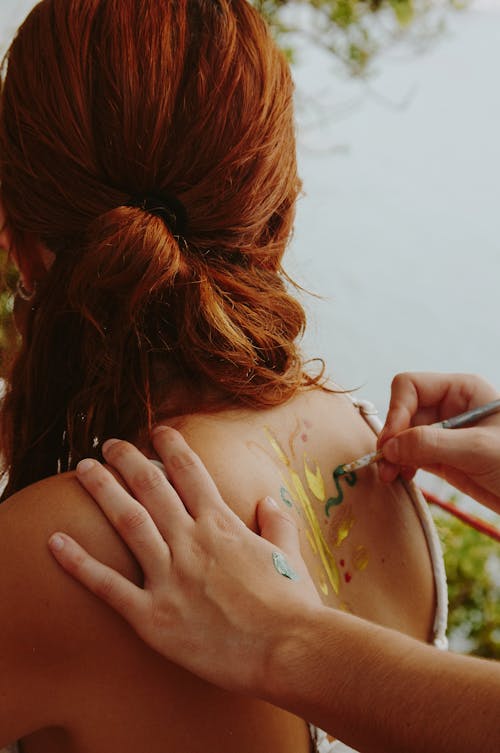 Man Drawing on Woman Back