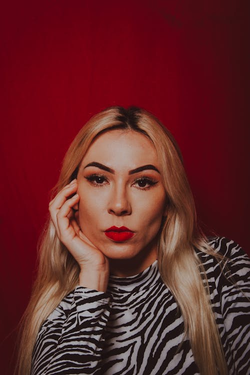 Portrait of Beautiful Woman on Red Background