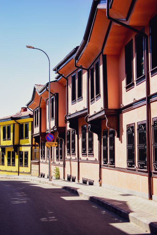 Free Charming urban street with colorful historic buildings under bright daylight. Stock Photo