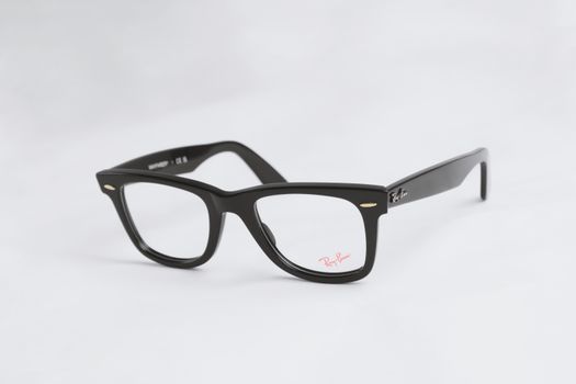 Classic black eyeglasses with Ray-Ban branding on a white backdrop, highlighting their sleek design.