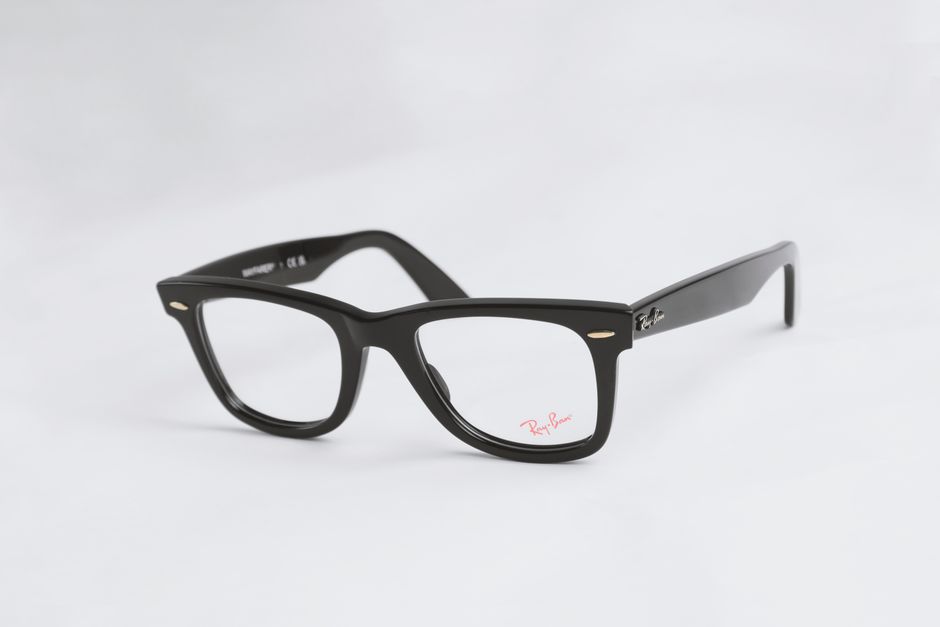 Classic black eyeglasses with Ray-Ban branding on a white backdrop, highlighting their sleek design.