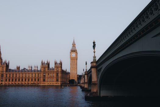 Iconic view of Big Ben and Westminster Bridge over the Thames River in London, England during the daytime.