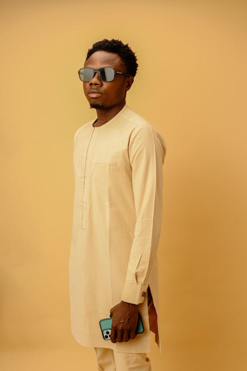 Young Black Man in Traditional Suit Posing in Studio