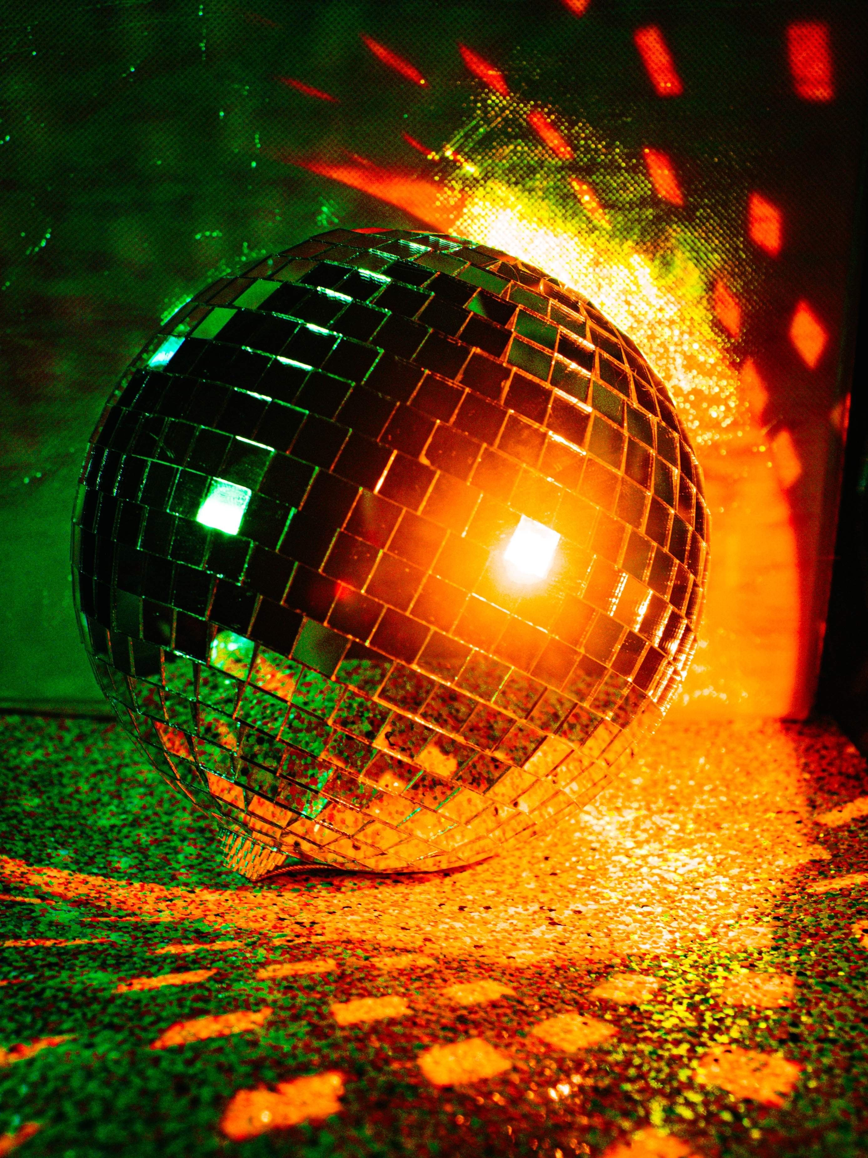 Disco ball glowing on the floor at a party