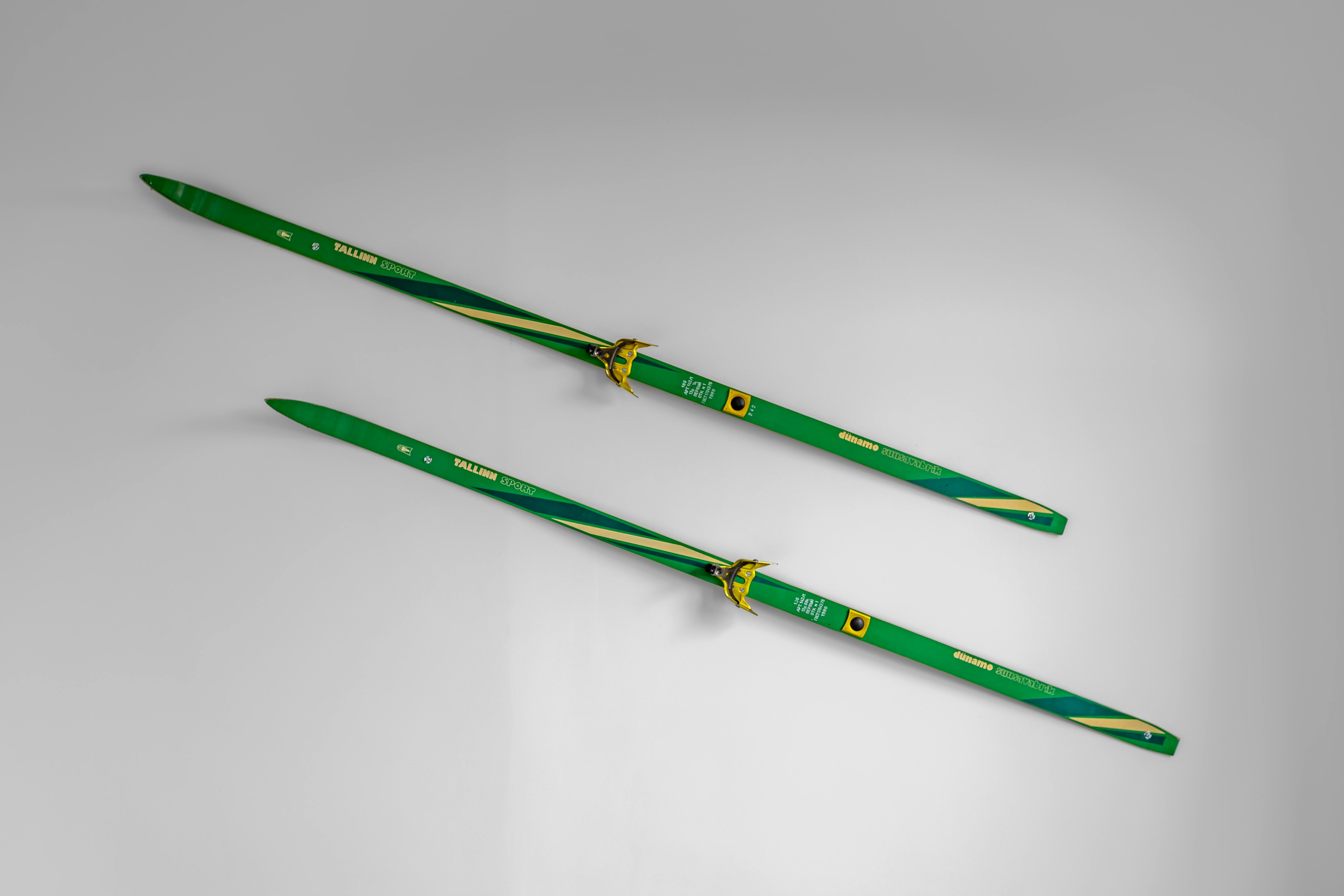 Prescription Goggle Inserts - Pair of green cross-country skis placed on a white background, ideal for winter sports themes.