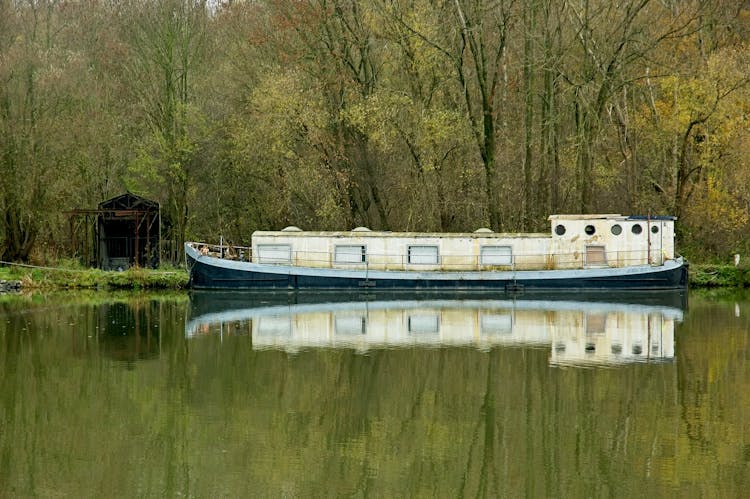 Old Boat Moored By The Forest