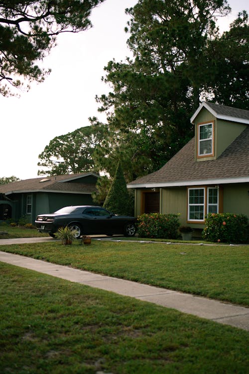 Residential House with a Car Parked in the Driveway 