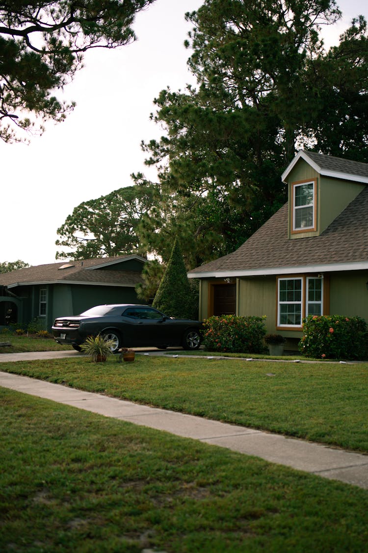 Residential House With A Car Parked In The Driveway 