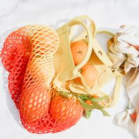 Oranges in a reusable mesh string bag — photo by Studio Naae on Pexels