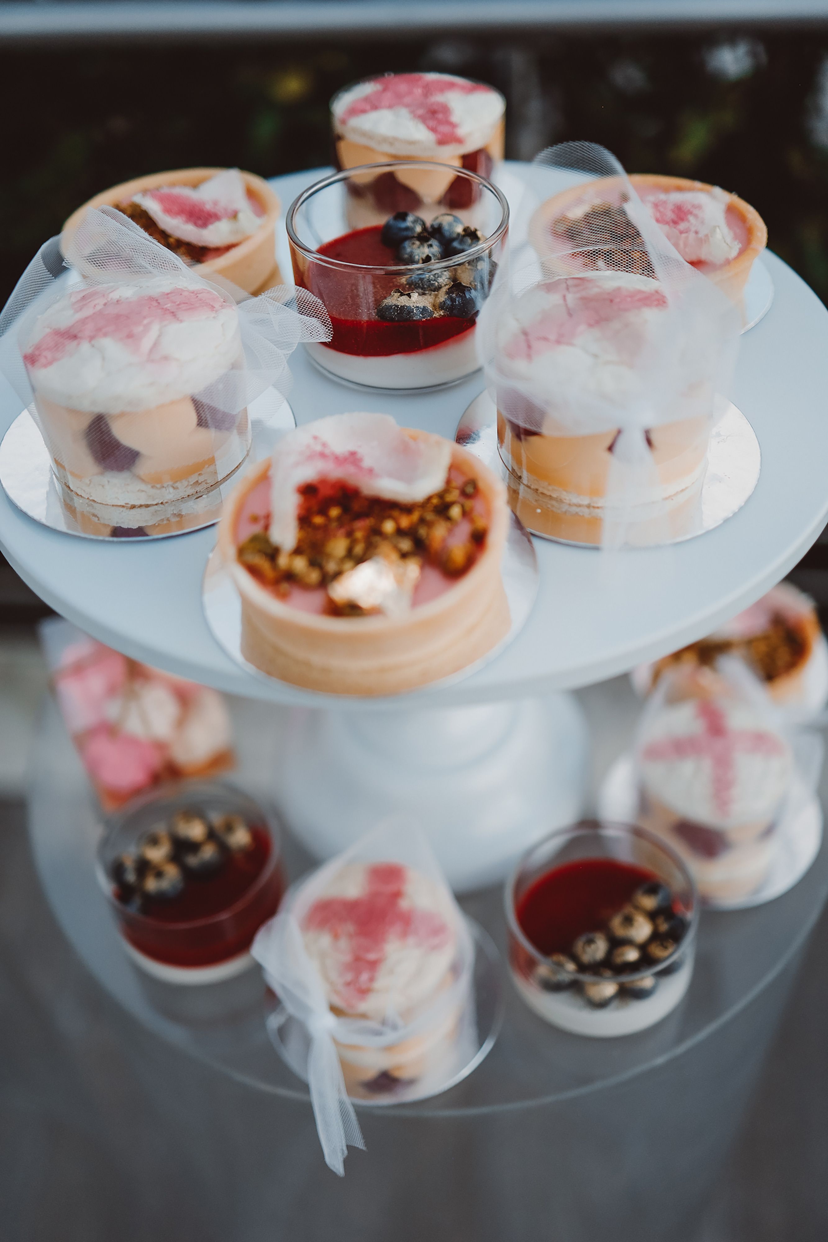 A beautifully presented selection of panna cotta and mousse desserts on a multi-tier stand, perfect for events.