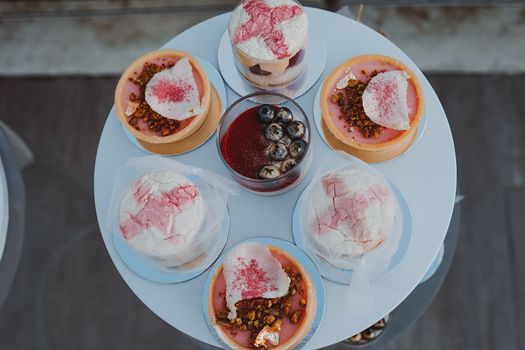 A charming selection of assorted cakes and desserts viewed from above.