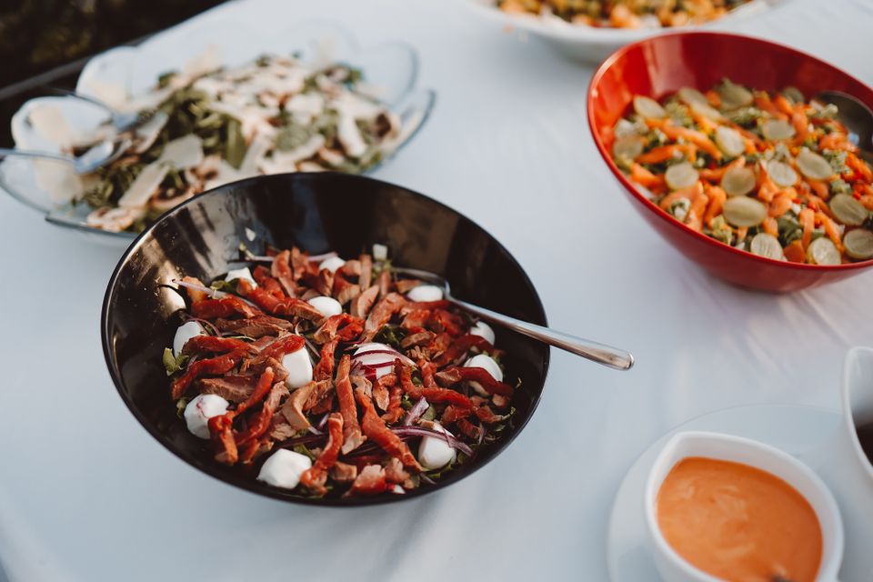 Bowls of summer salads on a laid table — photo by Alejandra Montenegro on Pexels