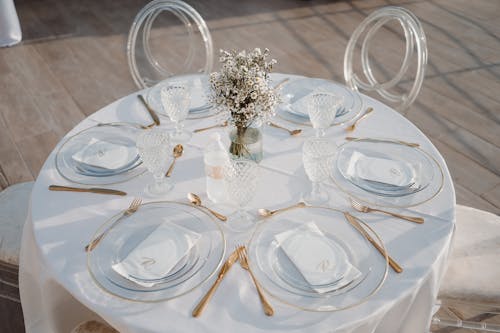 Restaurant Table Set with Glass Plates and Golden Cutlery