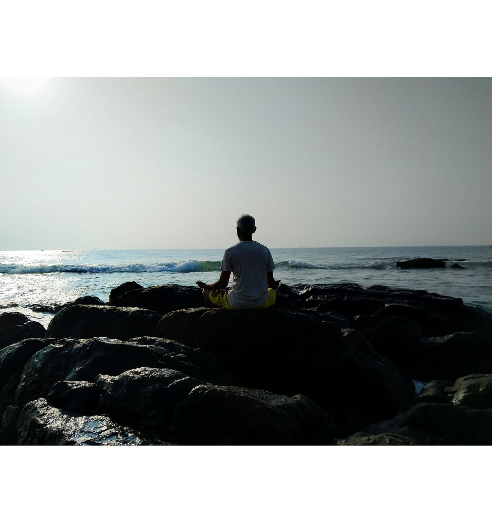 Person practicing yoga on the beach