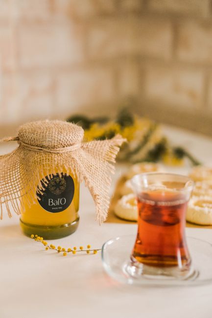 A close-up still life featuring Turkish tea and a honey jar with a rustic cover. - Common Misconceptions About Honey and Health Claims