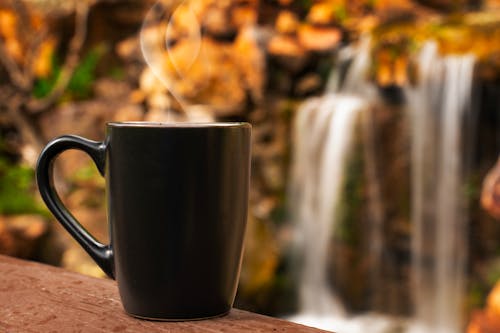 Cup of Coffee in Front of a Waterfall 