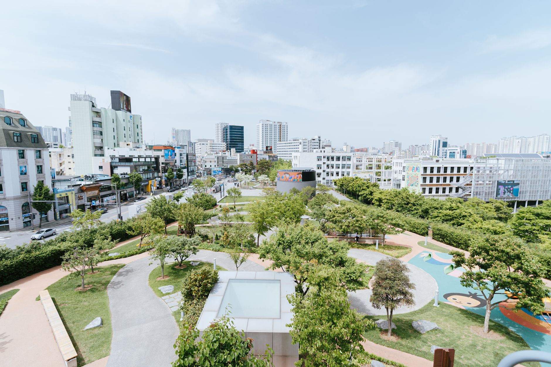 Breathtaking aerial view of a vibrant urban park surrounded by city buildings.
